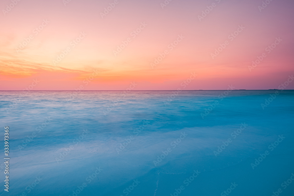 Peaceful tropical sunset beach with bokeh sun light wave abstract background. Copy space of outdoor summer vacation and travel adventure concept. Vintage tone filter color style.