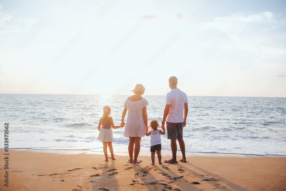 Holiday travel concept, Summer vacations. Happy family are having fun on a tropical beach in sunset.