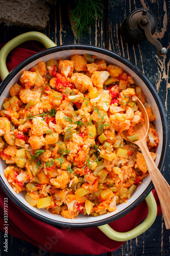 Vegetable stew with cauliflower, zucchini, celery, beans, carrots and onions, top view, selective focus