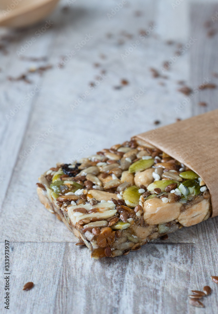 Superfood breakfast homemade bars with oats and seeds, on white wooden background