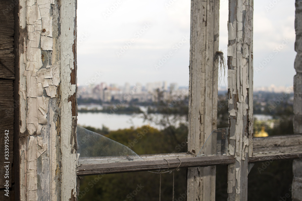 Old wooden frame of a broken window on a background of cityscape