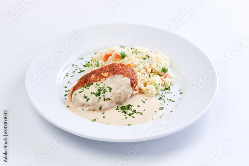 cutlet with rice and vegetables on the white background
