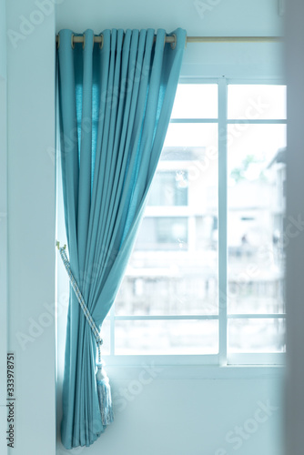 Blue curtains and windows shining in the sun © Itagaki