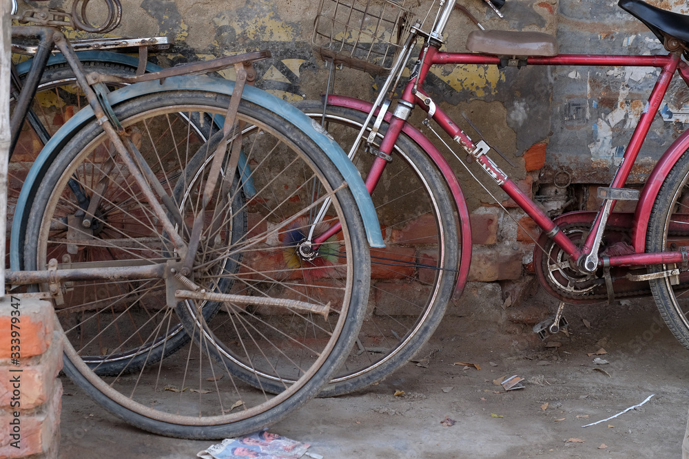 Bicycle leaning on wall in Kumrokhali, West Bengal, India