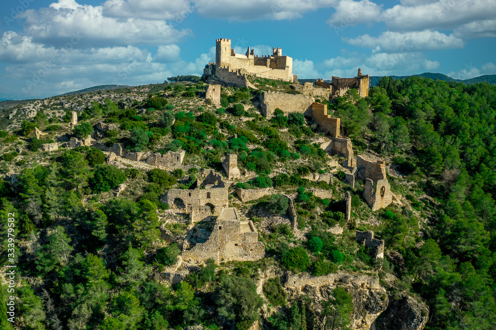 Aerial panorama view with cloudy sky of Alcala de Xivert ruined medieval castle in Spain of the templar knights