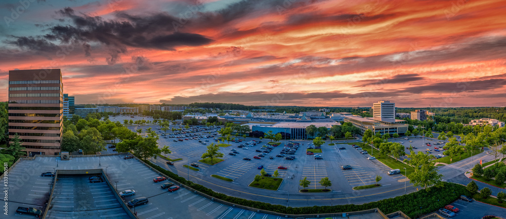 Aerial sunset view of Columbia town center in Howard Country Maryland with dramatic red, orange, blue, purple colors over the office and residential buildings