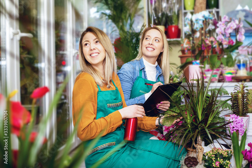 Two Young Woman Working with  Flower  in flower shop