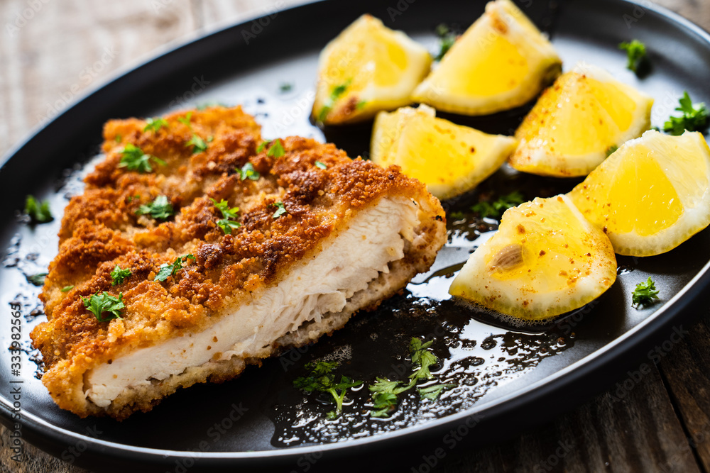 Pork chop with lemon and lemon on wooden background Pork chop with lemon and lemon on wooden background