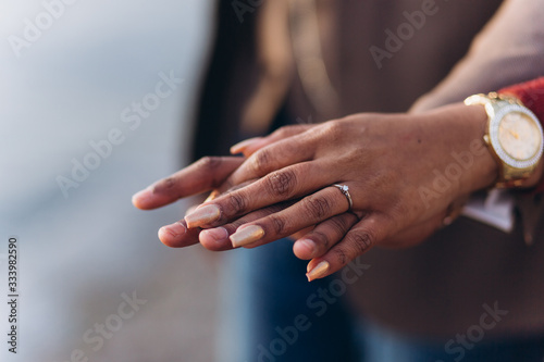 Hands of loving happy couple hugging outdoors together. Dating and romance time for loving people. Proposal concept