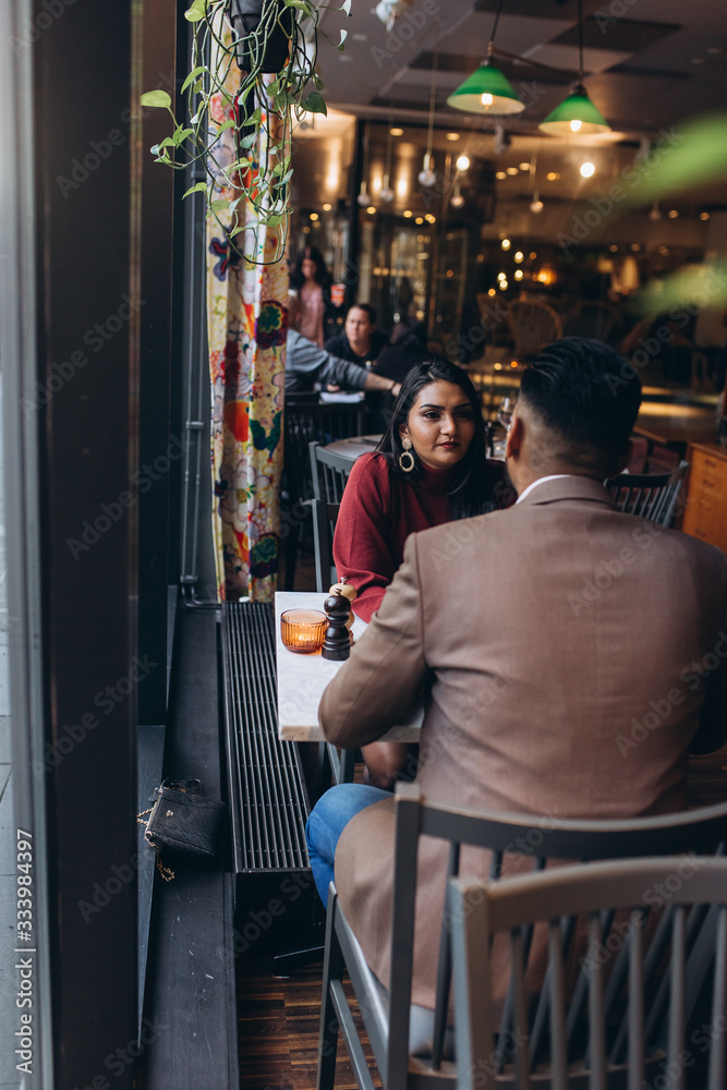 Young loving couple in cafe together. Love, family concept Young loving couple in cafe together. Love, family concept