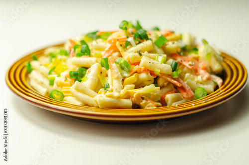 Cavatelli pasta with iceberg lettuce, carrots, sweet corn, cucumber and chive in a sauce mayonnaise