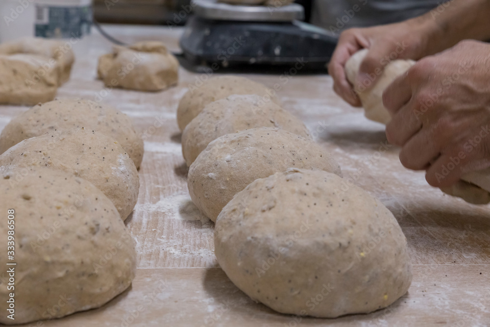 Baker preparing the bread dough Baker preparing the bread dough