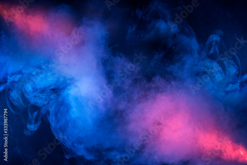 Abstract texture of backlit smoke in red blue on a black background. photo