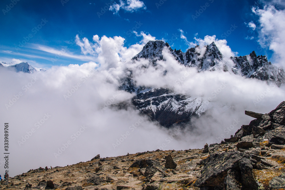 Snow covered beautiful mountain peaks and soft white clouds