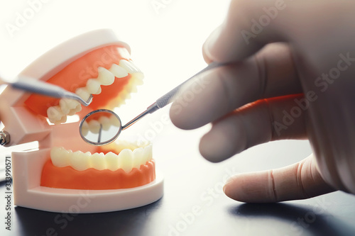 Dentist's office. Dentist examines the oral cavity before treatment. The doctor shows a course of treatment. Caries jaw treatment. Implantation and installation of veneers.