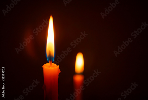 Candle lit in the dark, Candle flame at night. Lighting design for background.