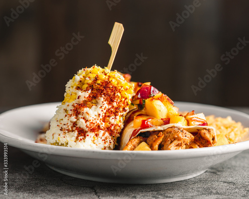 Beautifully plated mexican chicken and pineapple burrito 45 degree angle shot