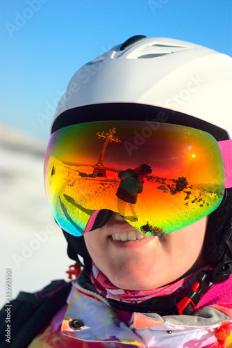 smiling masked woman snowboarder