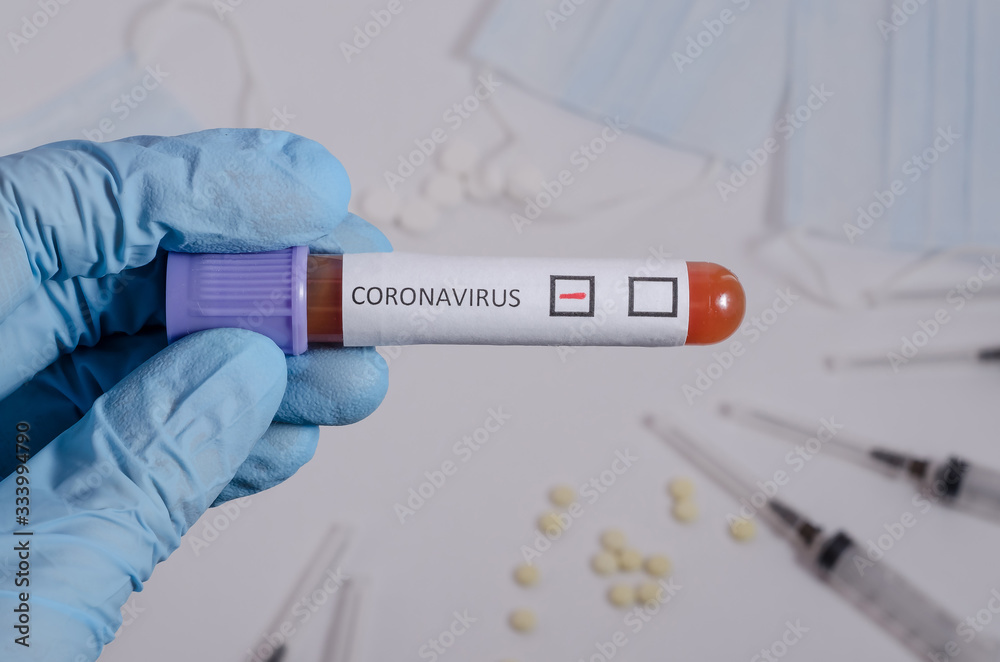 Obraz premium Negative blood test for coronavirus, surgical medical mask and medication on a white background, pneumonia and bronchitis concept. Viral infection.
