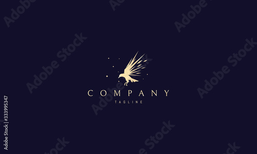 Vector golden logo on which an abstract image of a flying raven with sharp wings.