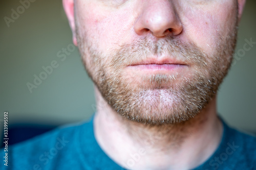 Chin, nose, and lips of unshaven white male photo