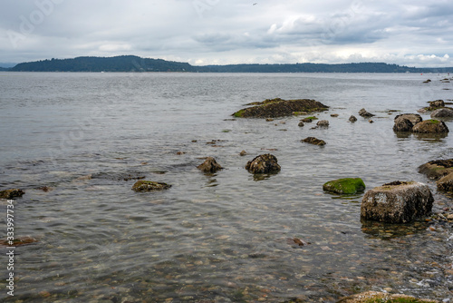 Incoming Tide covers beach rocks in Seattle