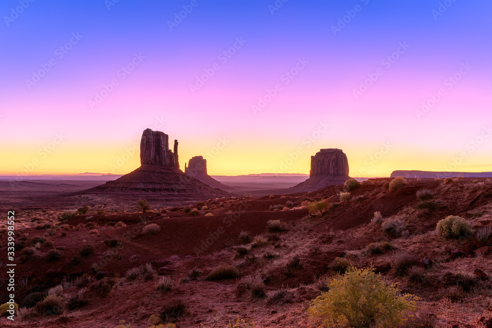 Beautiful colorful sunrise view of famous Buttes of Monument Valley on the border between Arizona and Utah, USA Beautiful colorful sunrise view of famous Buttes of Monument Valley on the border between Arizona and Utah, USA