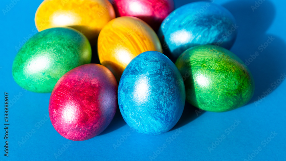 Colorful easter eggs on blue background. Happy Easter composition. Copy space. Colorful easter eggs on blue background. Happy Easter composition. Copy space.