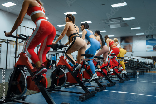 Wallpaper Mural Women doing exercise on stationary bike, back view Torontodigital.ca