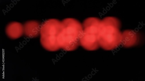 Background of red numbers that are out of focus. Counter with blurry numbers. photo