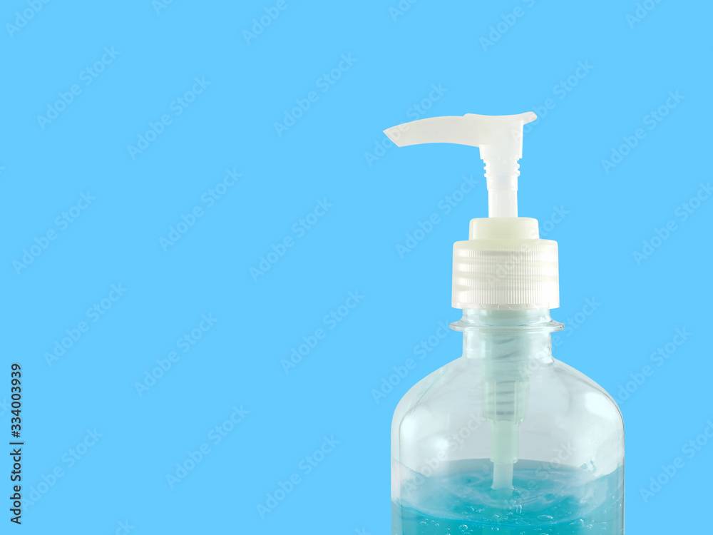closeup hand sanitizer in transparent bottle with pump lid isolated on blue closeup hand sanitizer in transparent bottle with pump lid isolated on blue
