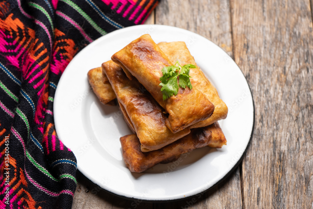 Mexican chimichanga on wooden background