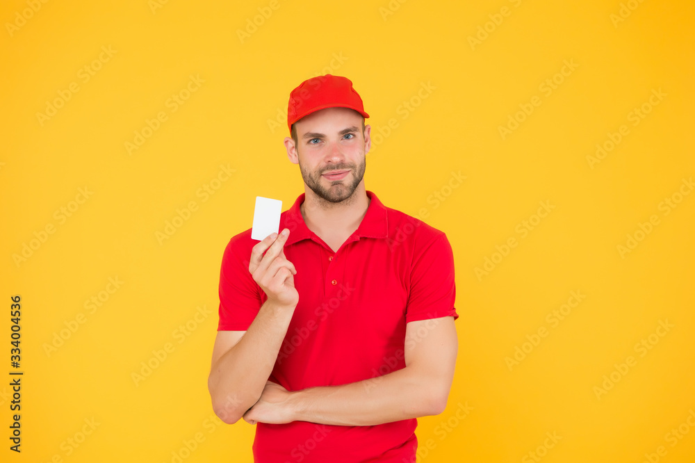 inscription of contacts. Person Delivery Man. Delivery man in red uniform. Male employee in cap and tshirt. process and acquire card payment. paying for delivery with credit card. Got loyalty card