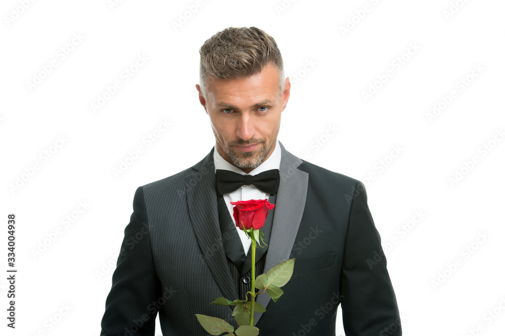 Celebrating womens day. Handsome man hold red rose. Flowers for womens day. Bachelor in formalwear. International womens day. March 8. Floral gift on womens day Celebrating womens day. Handsome man hold red rose. Flowers for womens day. Bachelor in formalwear. International womens day. March 8. Floral gift on womens day