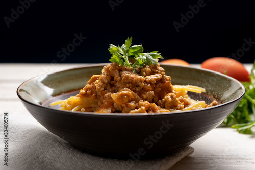 Spaghetti bolognese with parmesan cheese on white background