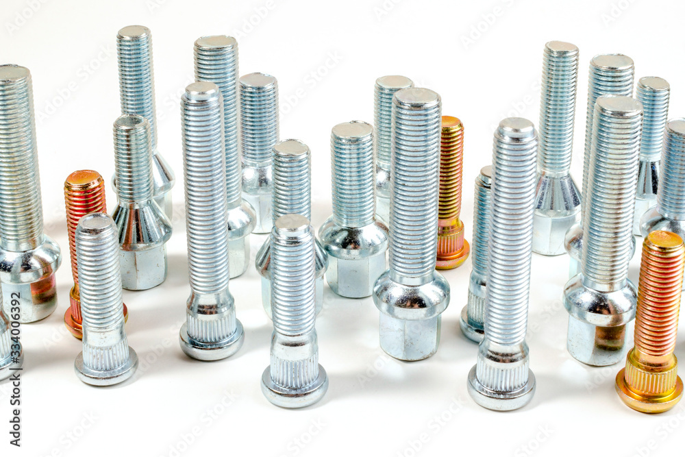 nuts and upright studs and bolts for a car on a table nuts and upright studs and bolts for a car on a table