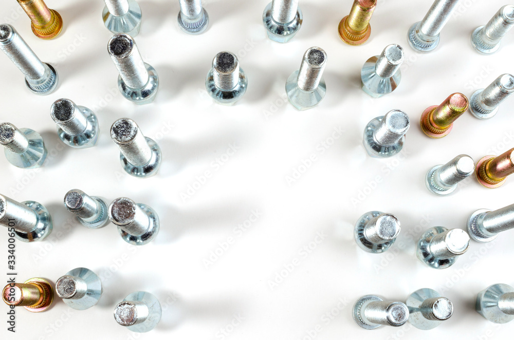 on a white background close-up new shiny nuts and bolts of a car top view on a white background close-up new shiny nuts and bolts of a car top view