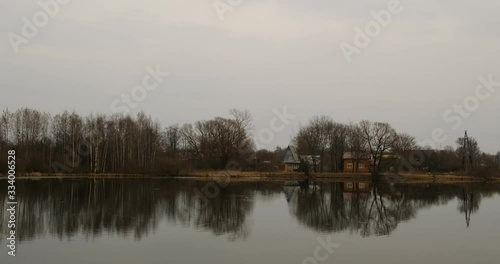 Small pond and old houses in the suburbs near Leningradskoye Shosse photo