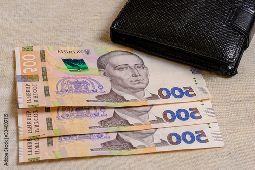 Five hundred Ukrainian hryvnia banknotes in black purse.