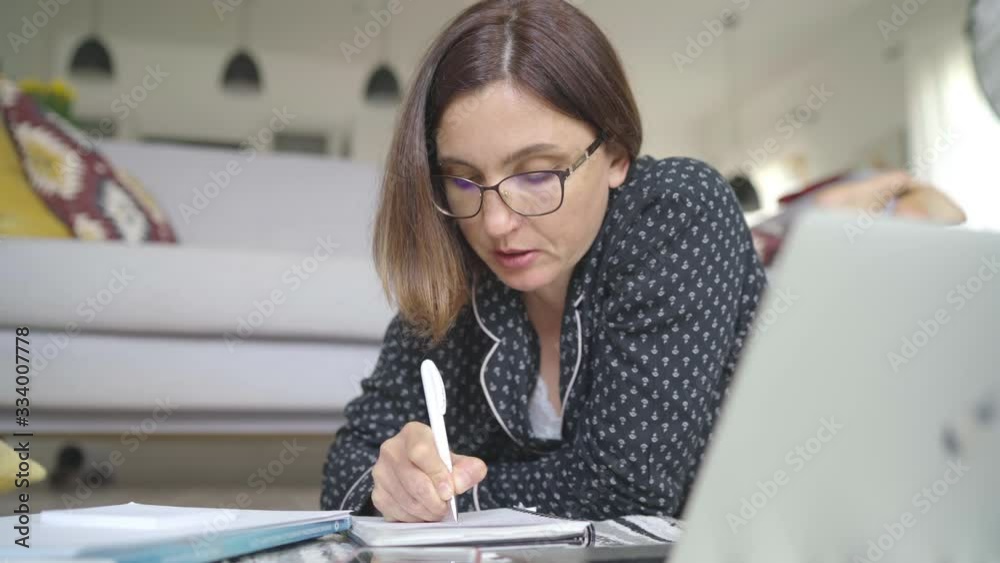 4K Woman manager wearing pajamas working from home - financial planner, accountant, investment banker, writer. Lockdown, quarantine, working from home concept.