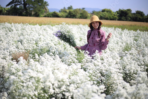 Woman holding flowers in Cutter flower fields at Mae Rim district, Chiang Mai, Thailand.