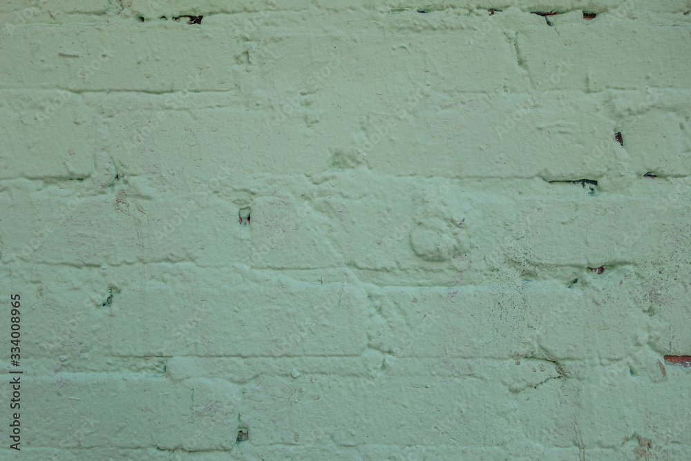 abstract background of an old brick wall painted light green close up abstract background of an old brick wall painted light green close up