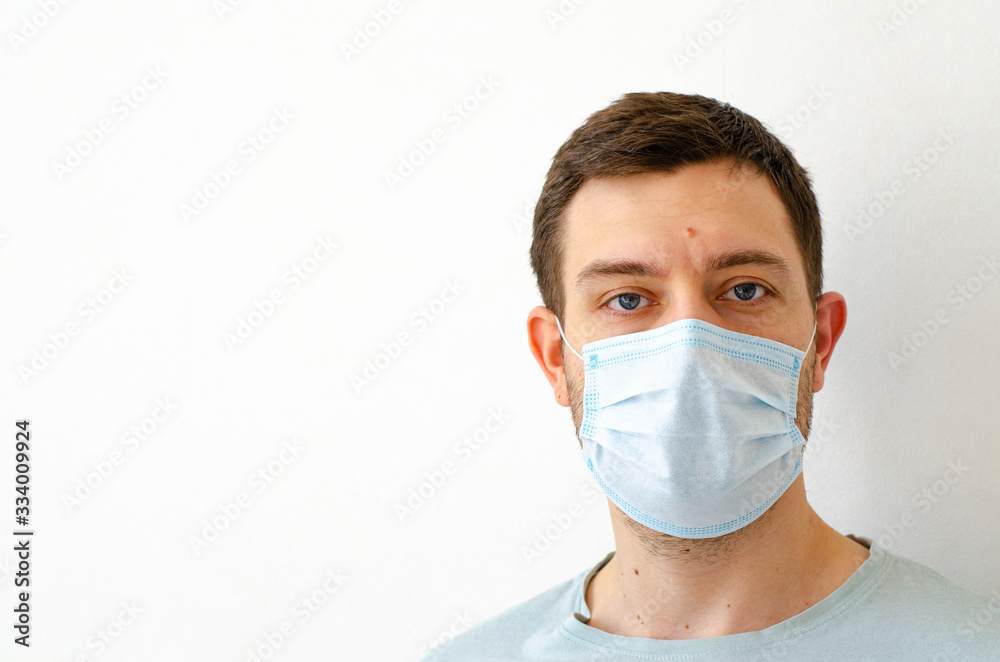 Coronavirus. Quarantine. A man puts on a mask. Virus protection.