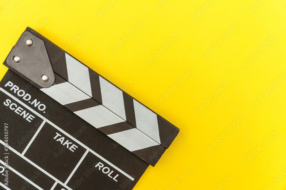 Filmmaker profession. Classic director empty film making clapperboard or movie slate isolated on yellow background. Video production film cinema industry concept. Flat lay top view copy space mock up.