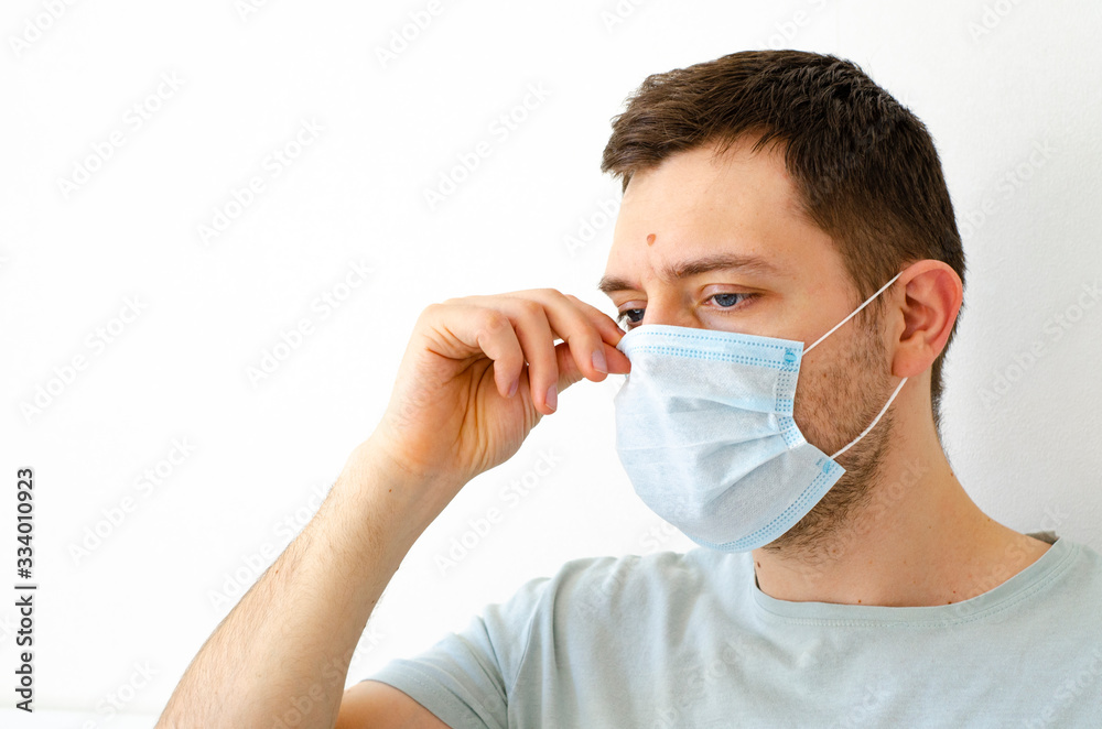 Coronavirus. Quarantine. A man puts on a mask. Virus protection.