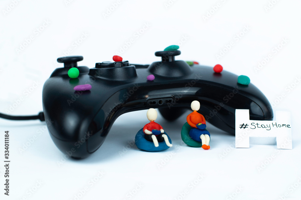 Close up on Plasticine family play games. Stick man family using joistick for enjoing their time at home. Stay home concept during quarantine. Hobby saves lives.