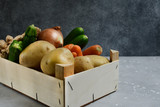 Delivery fresh organic vegetables home. product delivery service. Eco potatoes, carrots, zucchini, onions and ginger in a wooden box. takeaway food in the covid-19 quarantine