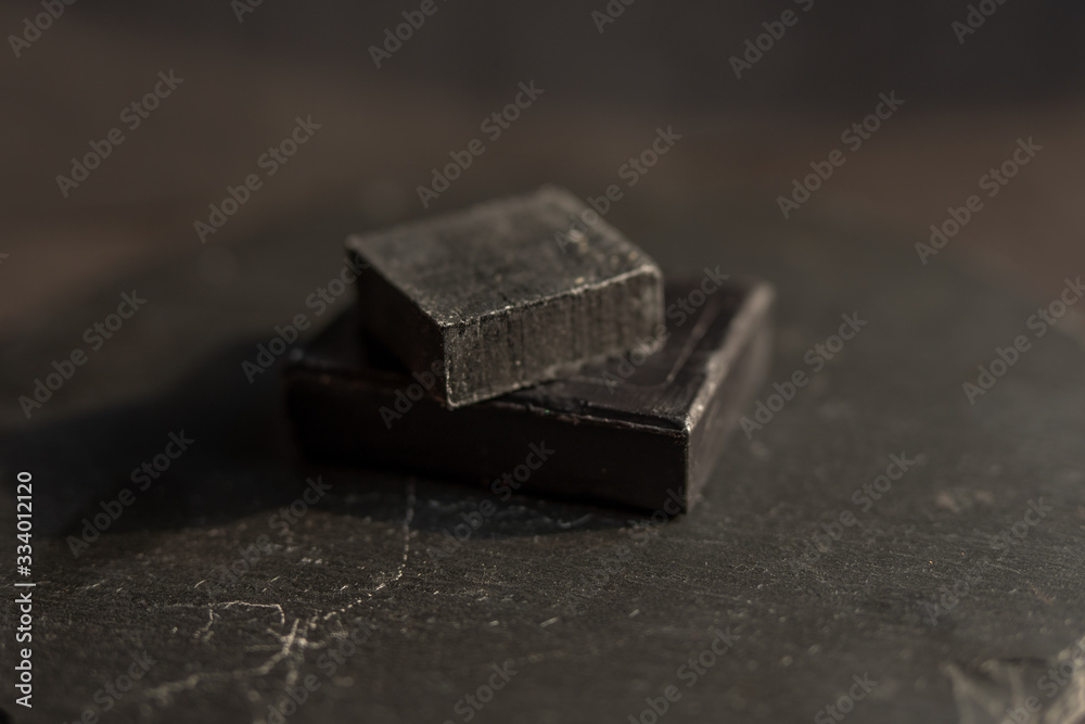 Black carbon charcoal soap on a black granit background 