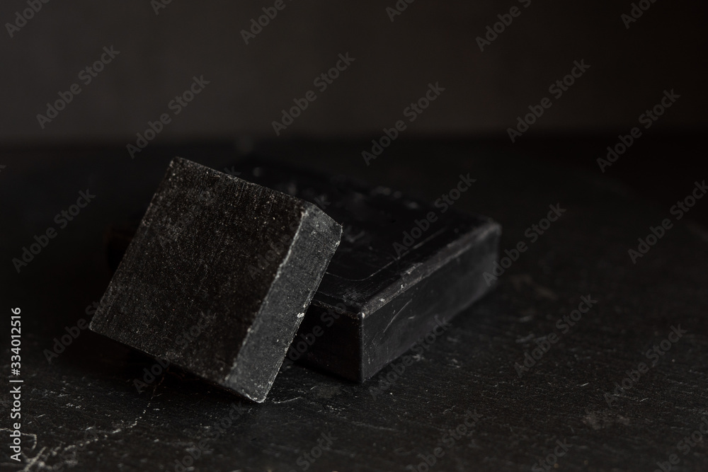 Black carbon charcoal soap on a black granit background Black carbon charcoal soap on a black granit background