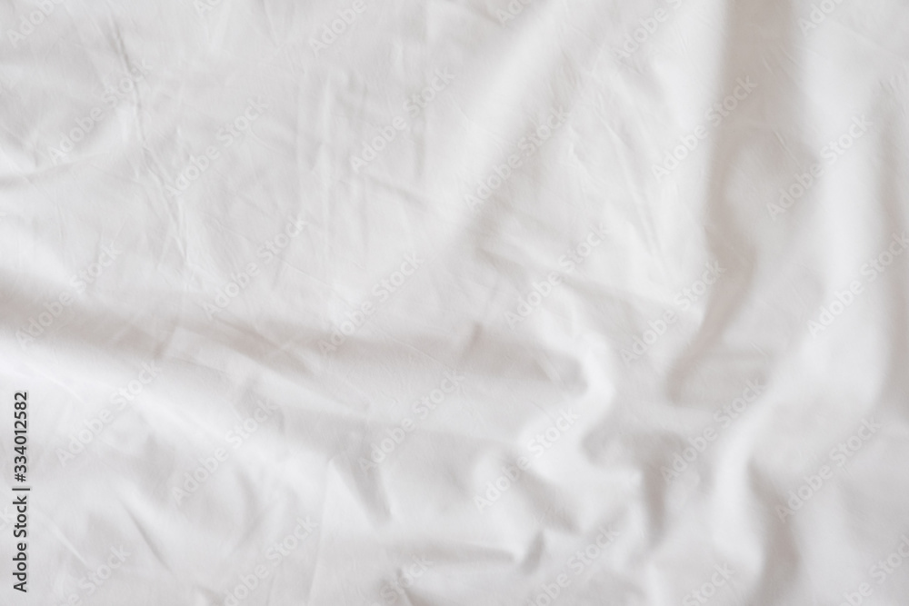 Background of white rumpled sheets. Bed linen with wrinkles in day light. Horizontal. Copy spase. Concept of rest, awakening, sleep, stay at home. For social media, blog Background of white rumpled sheets. Bed linen with wrinkles in day light. Horizontal. Copy spase. Concept of rest, awakening, sleep, stay at home. For social media, blog